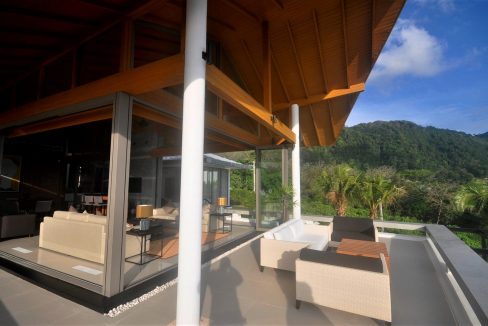 18. Top level outdoor lounge, with big tropical mountains to the sides ...